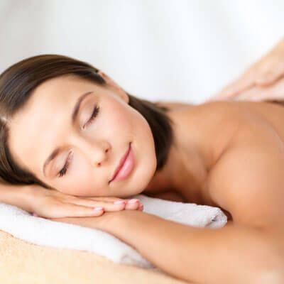 A woman receiving a back massage.