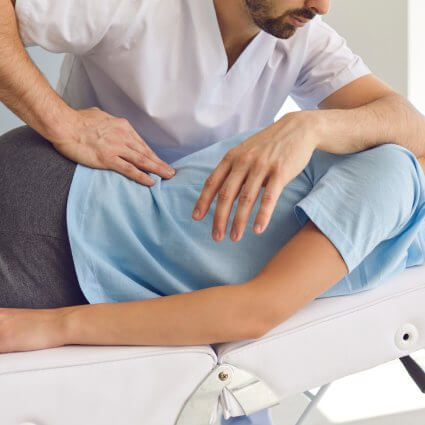 Adjusting woman on table