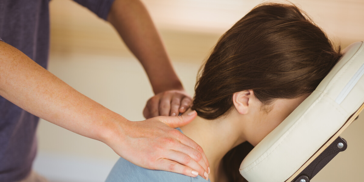 Massage therapist treating a patient's neck