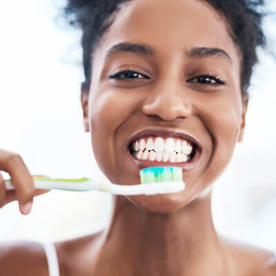 Woman smiling big with toothbrush