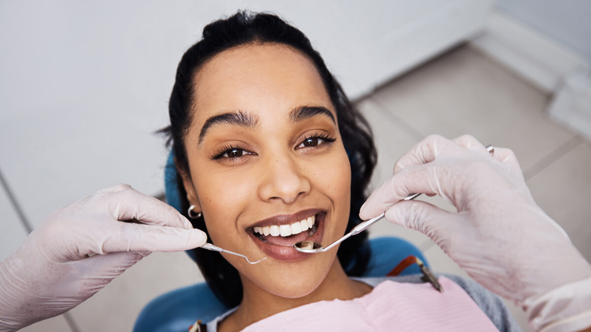 Smiling patient getting her teeth checked