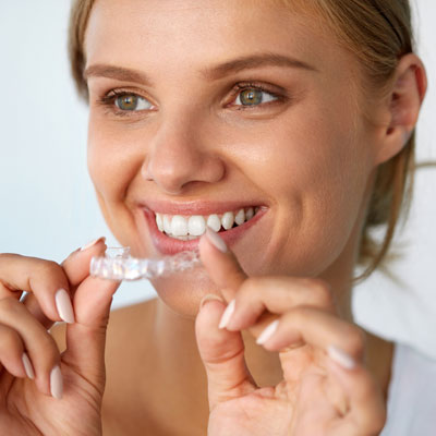 woman smiling with invisalign tray