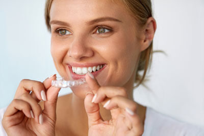 woman smiling with clear aligner