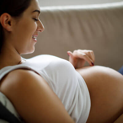 Pregnant woman looking at her belly