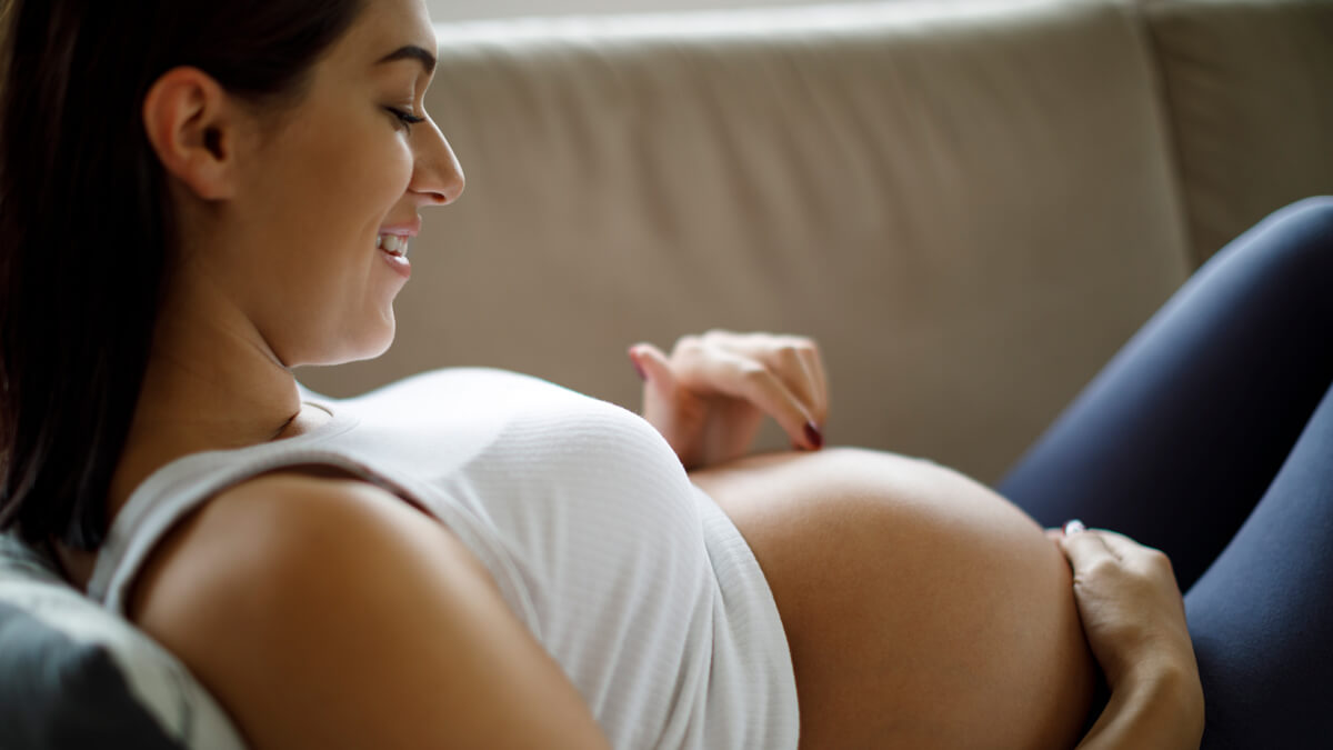 Woman looking at pregnant belly