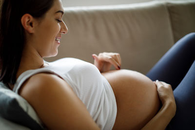 Woman touching pregnant belly