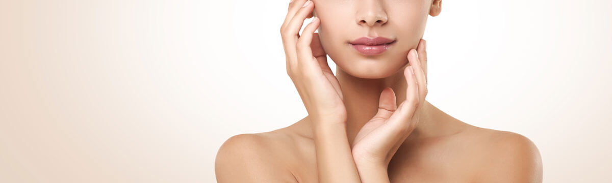 Woman gently touching her face