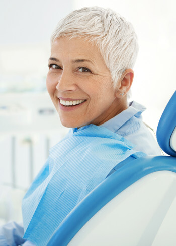 woman turned backwards in dental chair