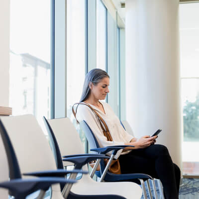 smiling person sitting in waiting area