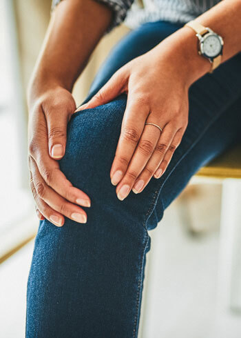 Woman holding knee