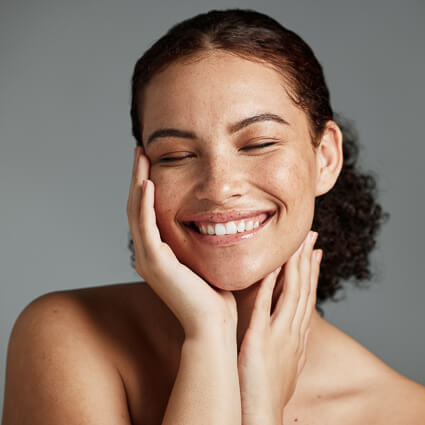 smiling woman resting her chin in her hands