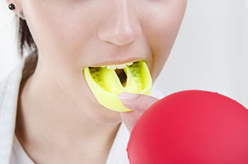 Woman putting in mouthguard