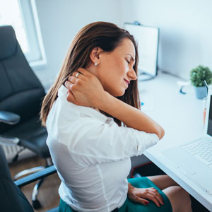 Woman holding neck in pain.