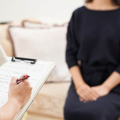 woman sitting on couch during consultation