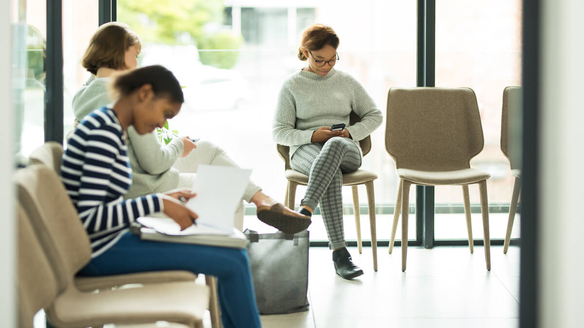 Patients sitting comfortably in a waiting room.