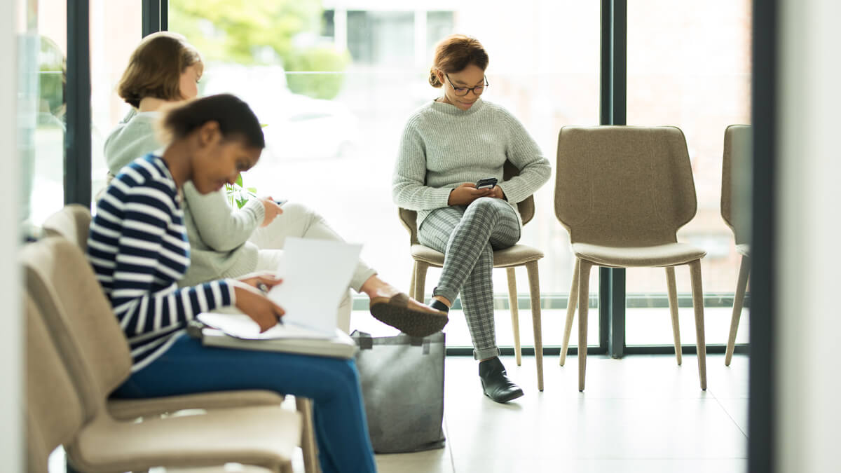 Patients sitting in a waiting room.