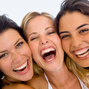 three women smiling and laughing