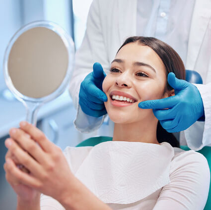 Woman looking in mirror smiling