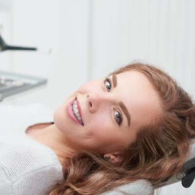 Woman in chair with braces