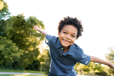 little boy smiling outdoors