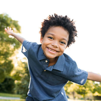 young boy smiling and playing