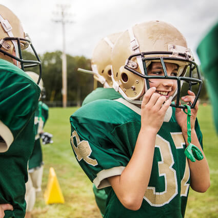 Young football player with mouthguard