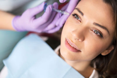 Woman getting facial injection