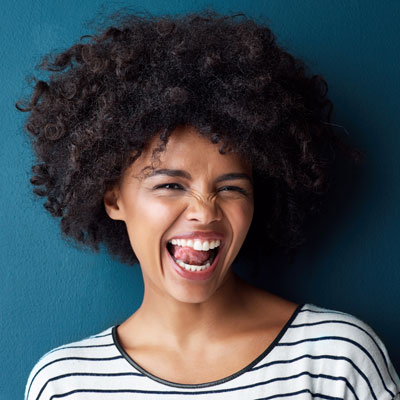 woman smiling and licking her tooth