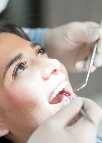 Woman getting teeth checked by dentist