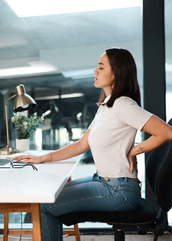 young woman modern office low back pain