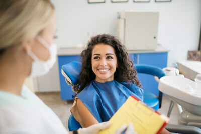young woman smiling at dentist
