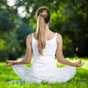 Woman meditating in park